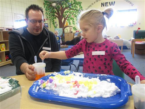 Child and dad playing with shaving cream